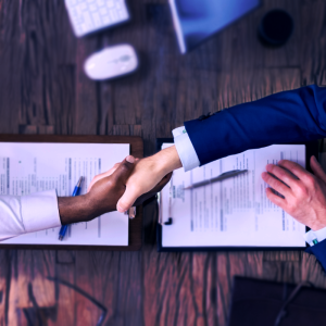 a financial advisor shaking hands with an interviewer