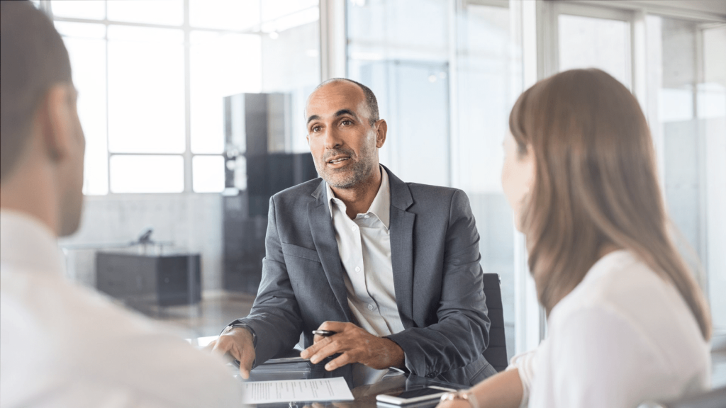 a man in a grey suit interviewing for a a job as a financial advisor at edward jones