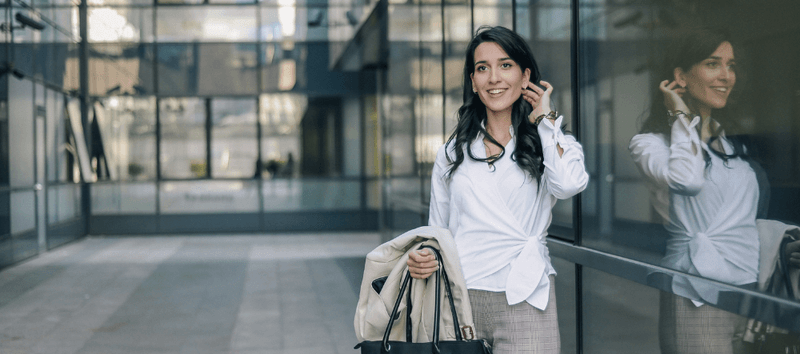 Female financial advisor outside of an office building. Learn more about how you can help the Financial Advisor Training Institute.