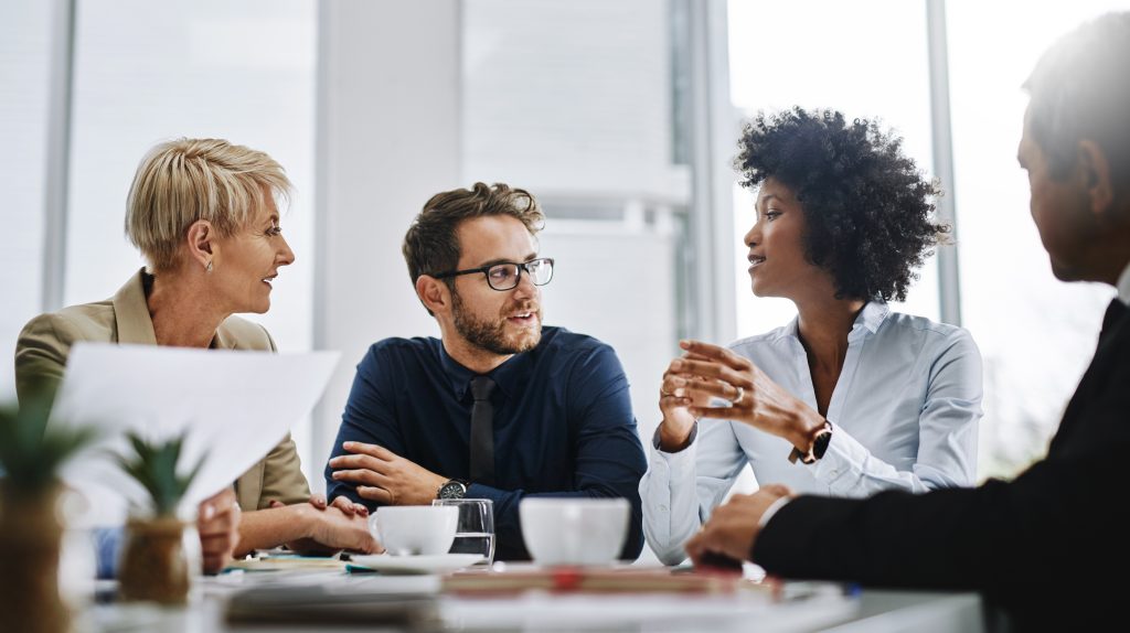 Group of people sitting at a table having a business discussion